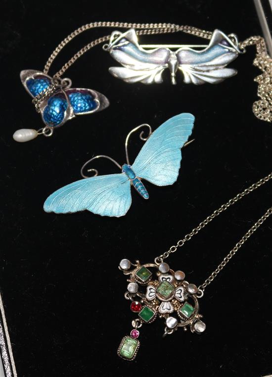 A 19th century continental gem set and enamel pendant necklace, a later silver & enamel pendant and two brooches.